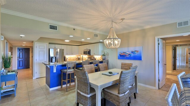 5300 S Atlantic Ave Unit 16-602, New Smyrna Beach, FL 32169 - dining area featuring light tile patterned floors, crown molding, a chandelier, baseboards, and recessed lighting