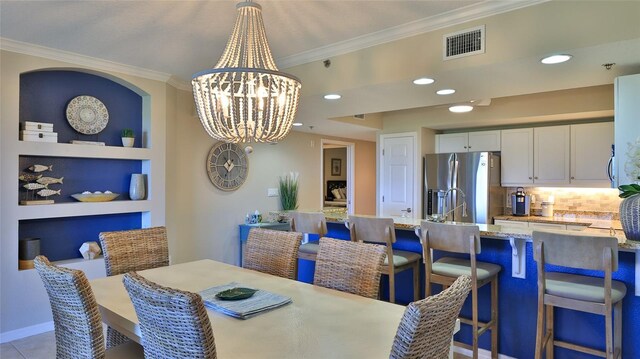 5300 S Atlantic Ave Unit 16-602, New Smyrna Beach, FL 32169 - dining room featuring a chandelier, crown molding, recessed lighting, and built in features