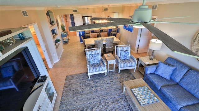 tiled living room featuring ceiling fan and crown molding