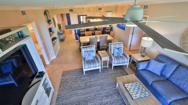 5300 S Atlantic Ave Unit 16-602, New Smyrna Beach, FL 32169 - tiled living room featuring ceiling fan, ornamental molding, and baseboards