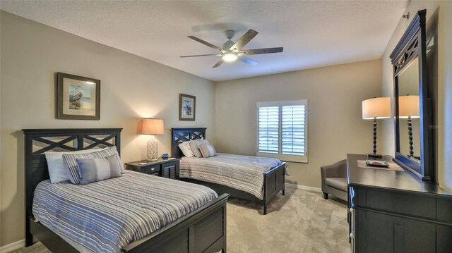 5300 S Atlantic Ave Unit 16-602, New Smyrna Beach, FL 32169 - bedroom featuring light colored carpet, baseboards, a textured ceiling, and ceiling fan