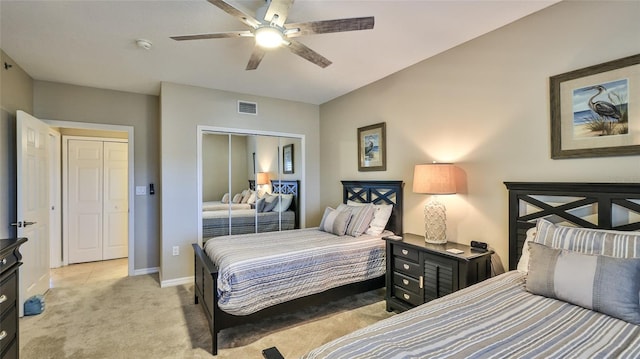 carpeted bedroom featuring ceiling fan and a closet