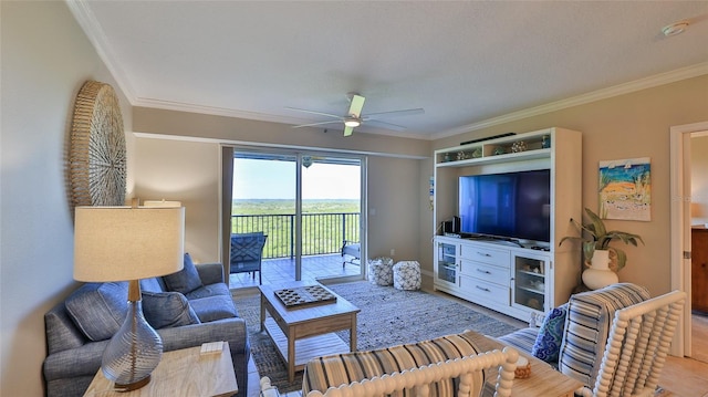 living room with ceiling fan and crown molding