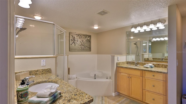 bathroom featuring shower with separate bathtub, a textured ceiling, tile patterned flooring, and vanity