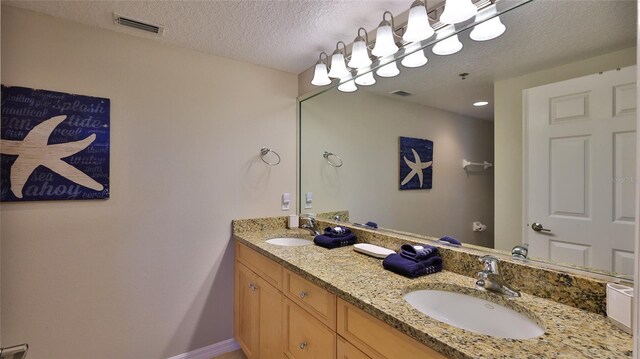 5300 S Atlantic Ave Unit 16-602, New Smyrna Beach, FL 32169 - full bath featuring double vanity, a textured ceiling, and baseboards