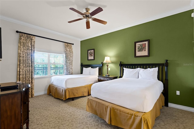 carpeted bedroom featuring ceiling fan and crown molding