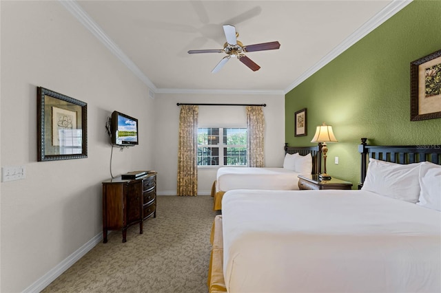 carpeted bedroom featuring ornamental molding and ceiling fan