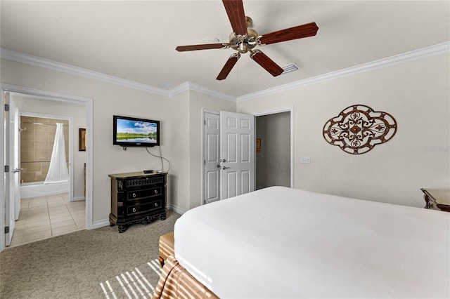 bedroom with ceiling fan, ornamental molding, light carpet, and ensuite bath