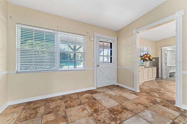 tiled foyer entrance featuring a healthy amount of sunlight