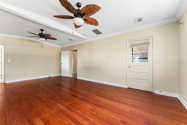 spare room featuring ceiling fan, wood-type flooring, a textured ceiling, beamed ceiling, and crown molding