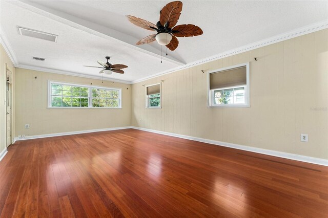 spare room with a textured ceiling, ceiling fan, ornamental molding, and hardwood / wood-style flooring