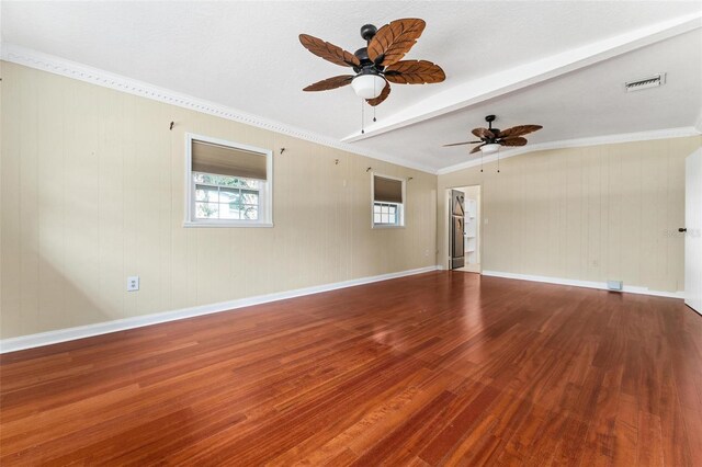 empty room featuring beamed ceiling, hardwood / wood-style flooring, ornamental molding, and ceiling fan