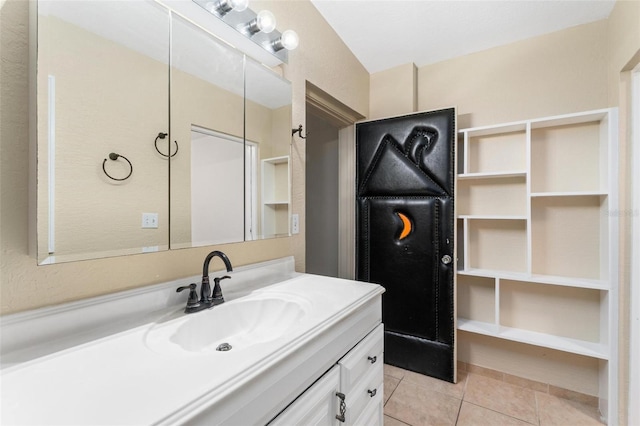 bathroom with tile patterned flooring and vanity