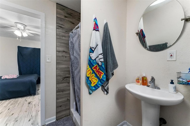 bathroom with ceiling fan and curtained shower