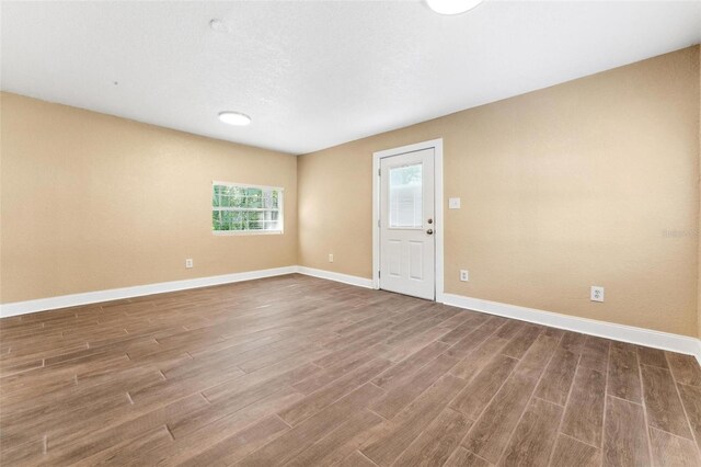 unfurnished room with hardwood / wood-style floors