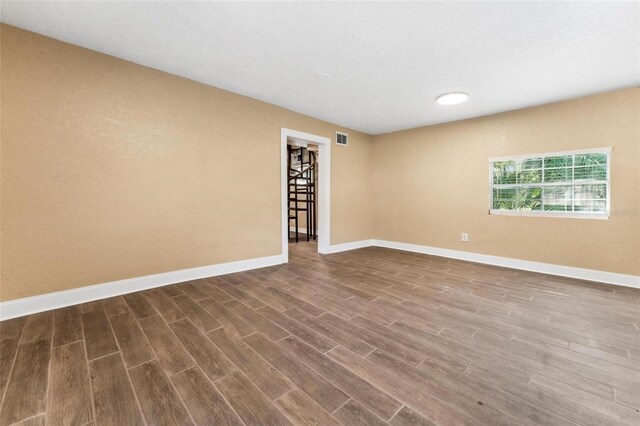 spare room featuring wood-type flooring