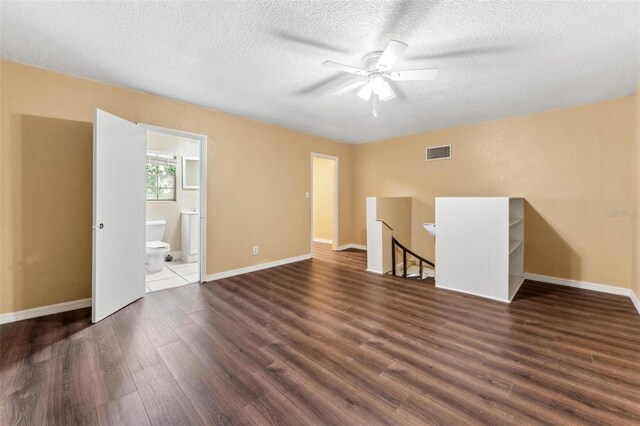 unfurnished living room featuring ceiling fan, wood-type flooring, and a textured ceiling