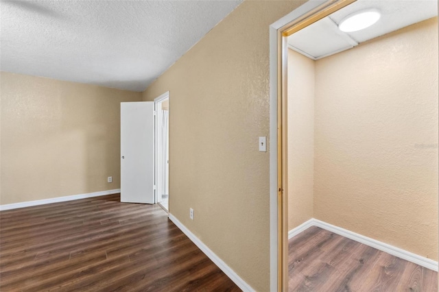 spare room with hardwood / wood-style flooring and a textured ceiling