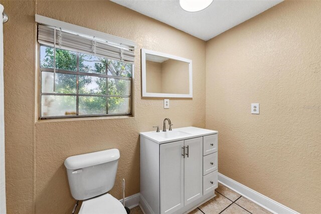 bathroom featuring tile patterned floors, vanity, and toilet