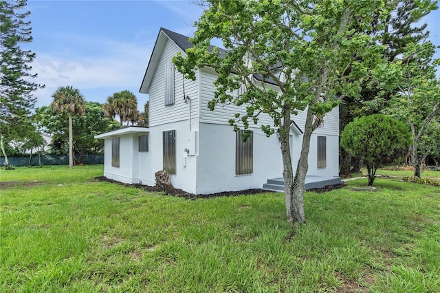 view of property exterior featuring a yard and stucco siding