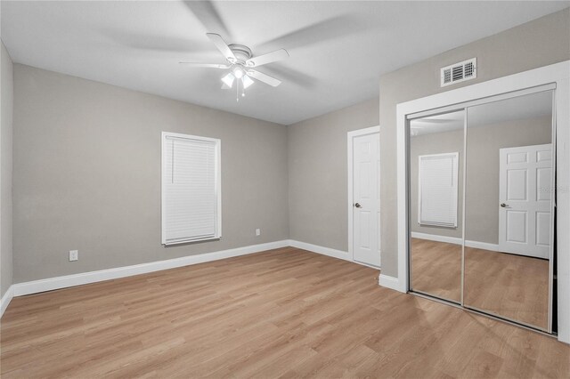 unfurnished bedroom with a closet, light wood-type flooring, and ceiling fan