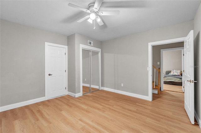 unfurnished bedroom with baseboards, visible vents, and light wood-style floors