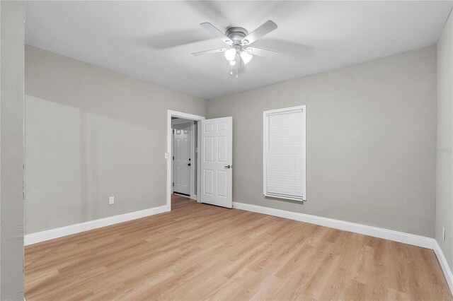 empty room featuring light wood-type flooring and ceiling fan