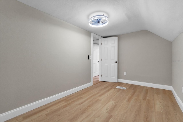 bonus room featuring light hardwood / wood-style floors and vaulted ceiling