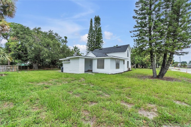 rear view of house with a yard