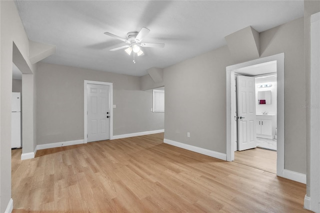 spare room with light wood-type flooring and ceiling fan