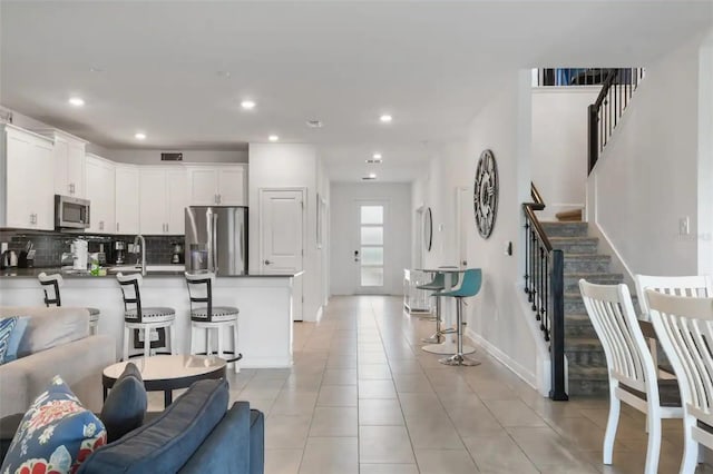 living room featuring light tile patterned floors and sink