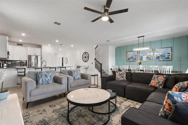 living room with ceiling fan and light tile patterned floors