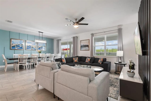 tiled living room featuring ceiling fan