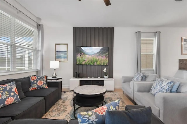 living room featuring hardwood / wood-style floors and ceiling fan