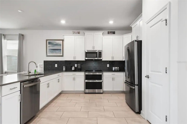 kitchen featuring sink, tasteful backsplash, appliances with stainless steel finishes, and light tile patterned flooring