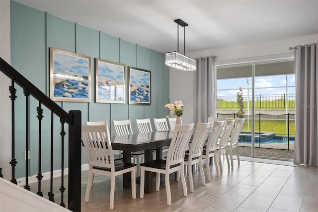 tiled dining area with a chandelier