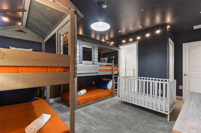 bedroom featuring vaulted ceiling and carpet flooring