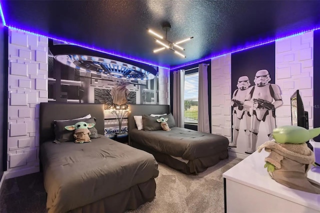 bedroom with a textured ceiling, carpet flooring, and ceiling fan