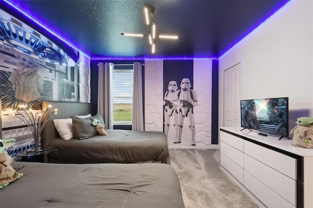 bedroom with a textured ceiling and light carpet