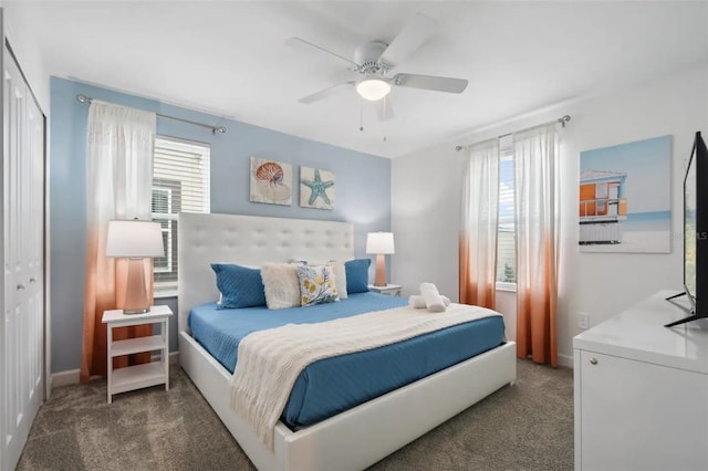 bedroom with ceiling fan, carpet flooring, a closet, and multiple windows