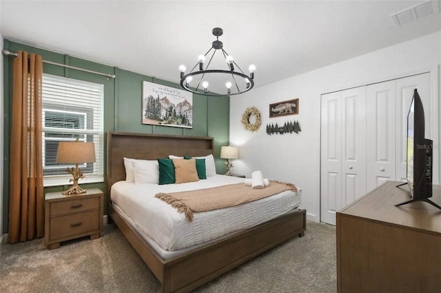 bedroom with carpet, a closet, and a chandelier