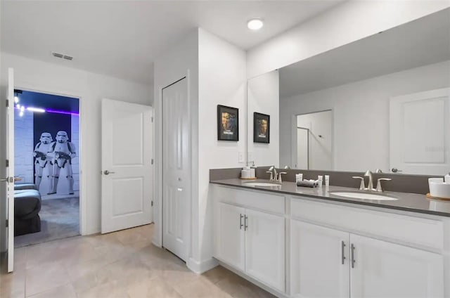 bathroom with tile patterned flooring and vanity