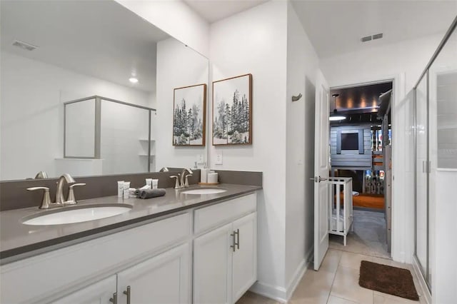 bathroom with tile patterned flooring, an enclosed shower, and vanity