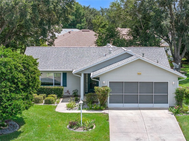 ranch-style home with a front yard and a garage