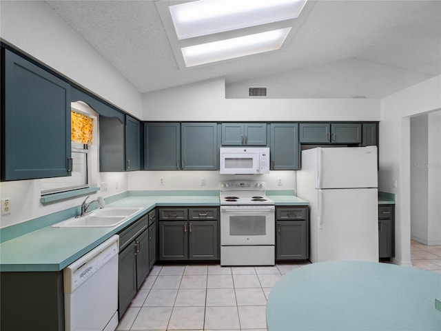 kitchen with lofted ceiling, white appliances, sink, a textured ceiling, and light tile patterned flooring