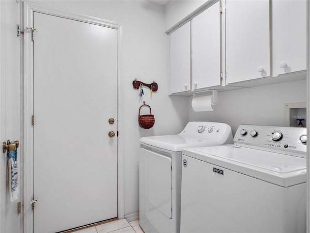 washroom featuring light tile patterned flooring, cabinets, and separate washer and dryer