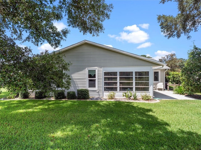 rear view of property with a patio area and a yard