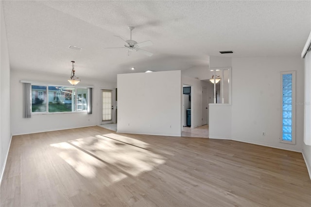 unfurnished living room featuring a textured ceiling, ceiling fan, light hardwood / wood-style flooring, and lofted ceiling