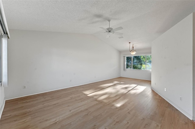 unfurnished room featuring a textured ceiling, ceiling fan, light hardwood / wood-style flooring, and vaulted ceiling