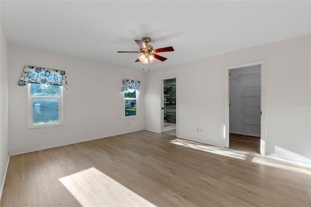 empty room with hardwood / wood-style flooring and ceiling fan